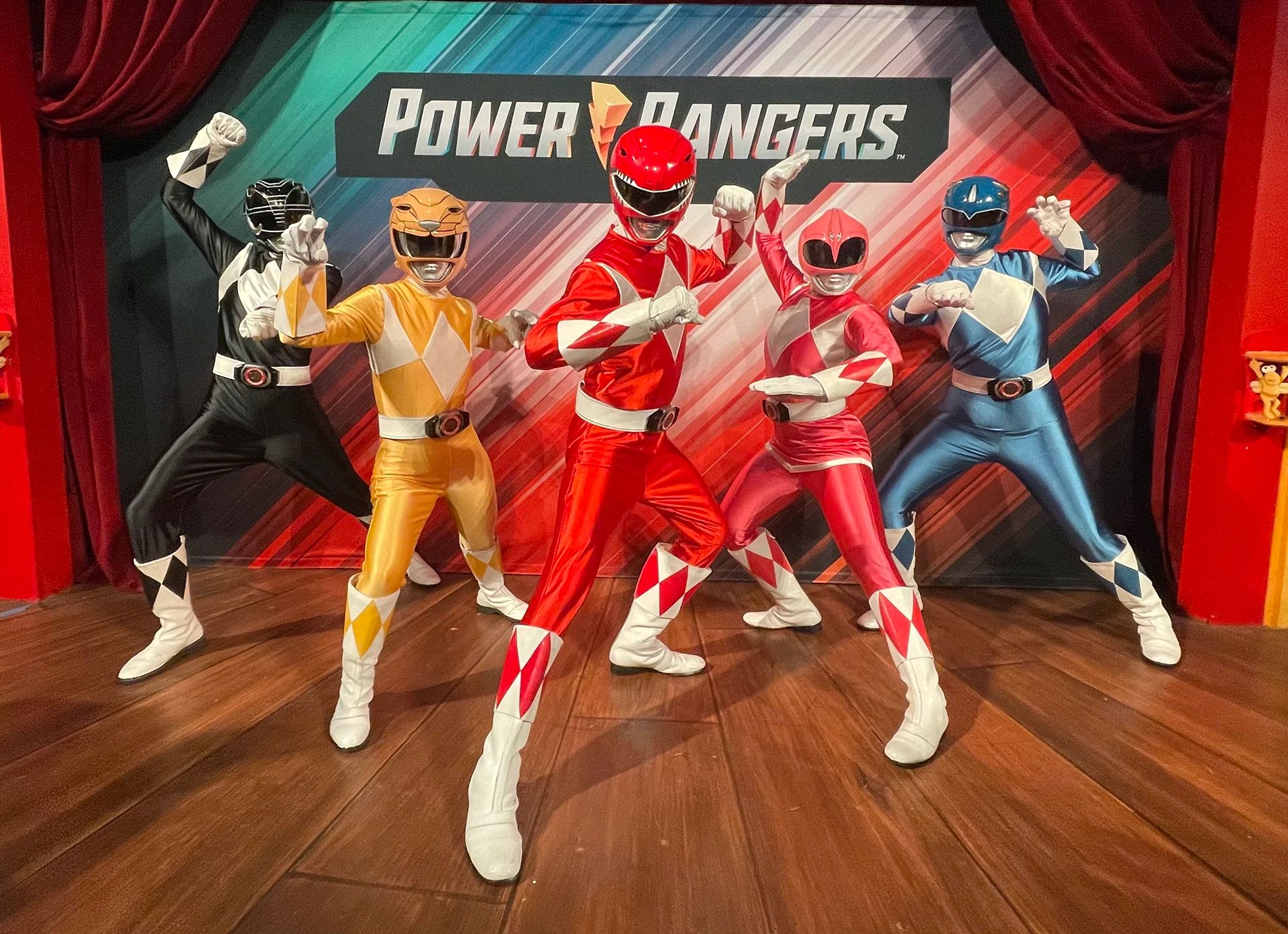 5 Power Rangers standing on a stage